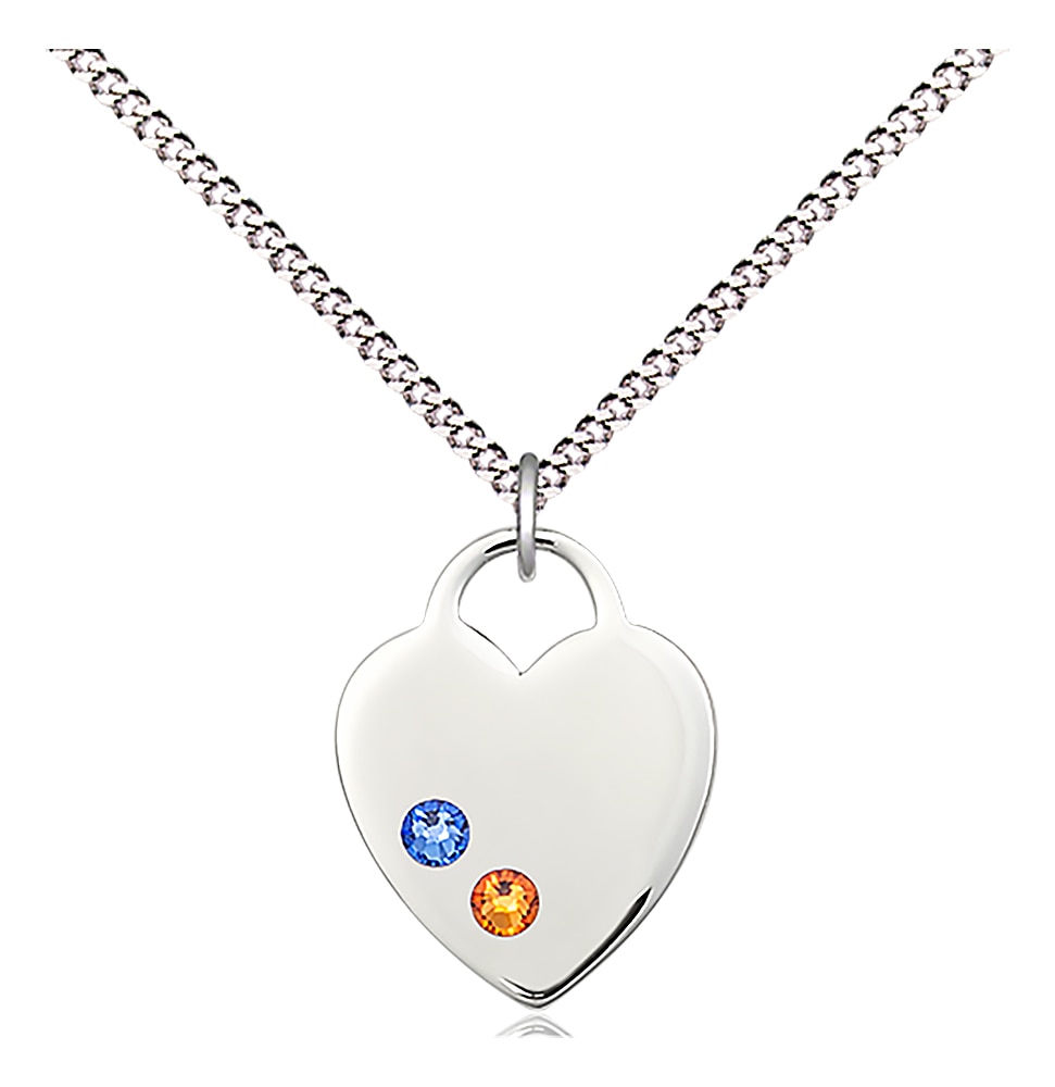 Heart Medal  Medal Measures 5/8-inch tall by 3/4-inch wide  Heart Features Dark Blue and Gold Colored Stones  Chain is 18 Inches in length Light Rhodium Light Curb Chain with Lobster Claw Clasp Handmade in the USA