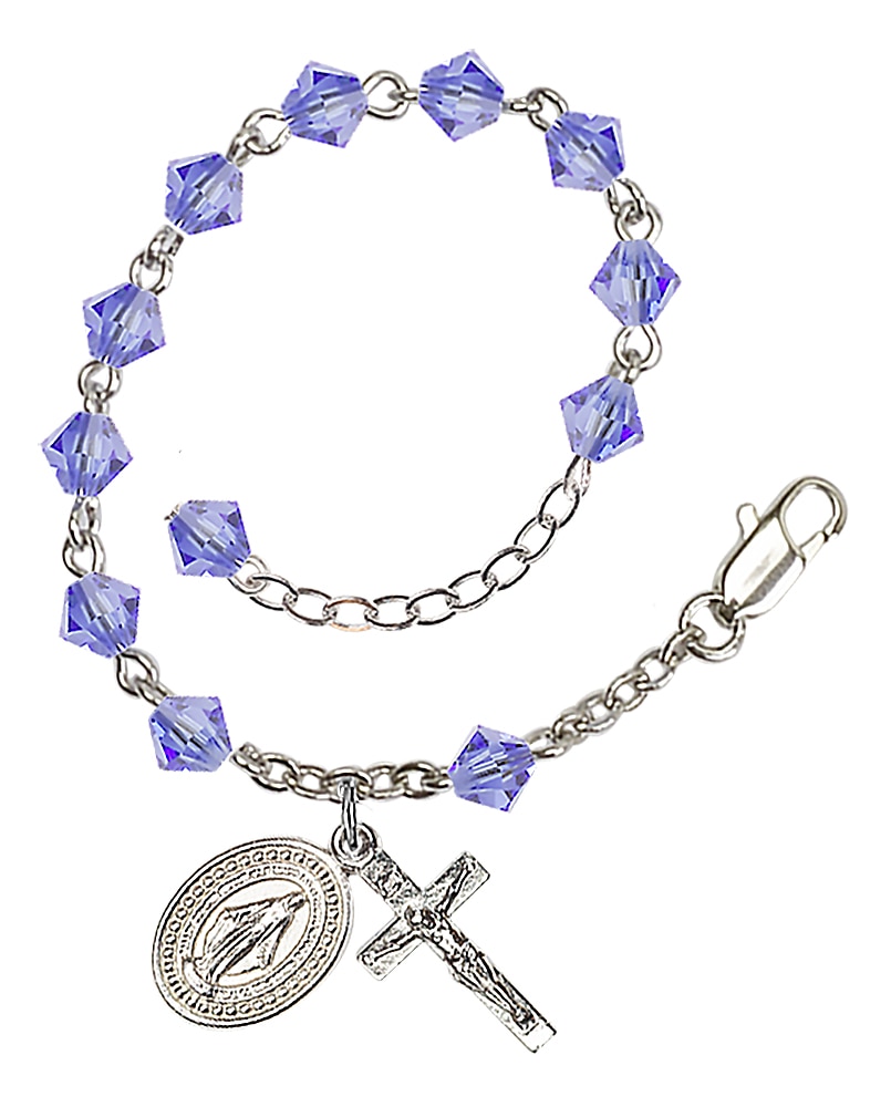 Rosary bracelet is Silver-Plated and can be adjusted between 7 1/2 and 8 1/2-inches   Beads are 5mm Light Blue, Bi-cone shaped, Austrian Crystal   Crucifix is 5/8-inch tall by 1/4-inch wide   Miraculous Medal is 1/2-inch tall by 1/4-inch wide Handmad