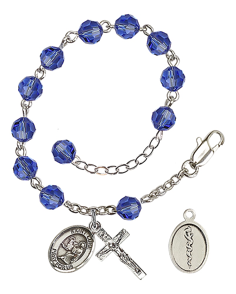 Rhodium Plated/Pewter 6mm Austrian Crystal Dark Blue Rosary Bracelet 7 1/2-inch with St. Luke/Doctor Charm and Crucifix